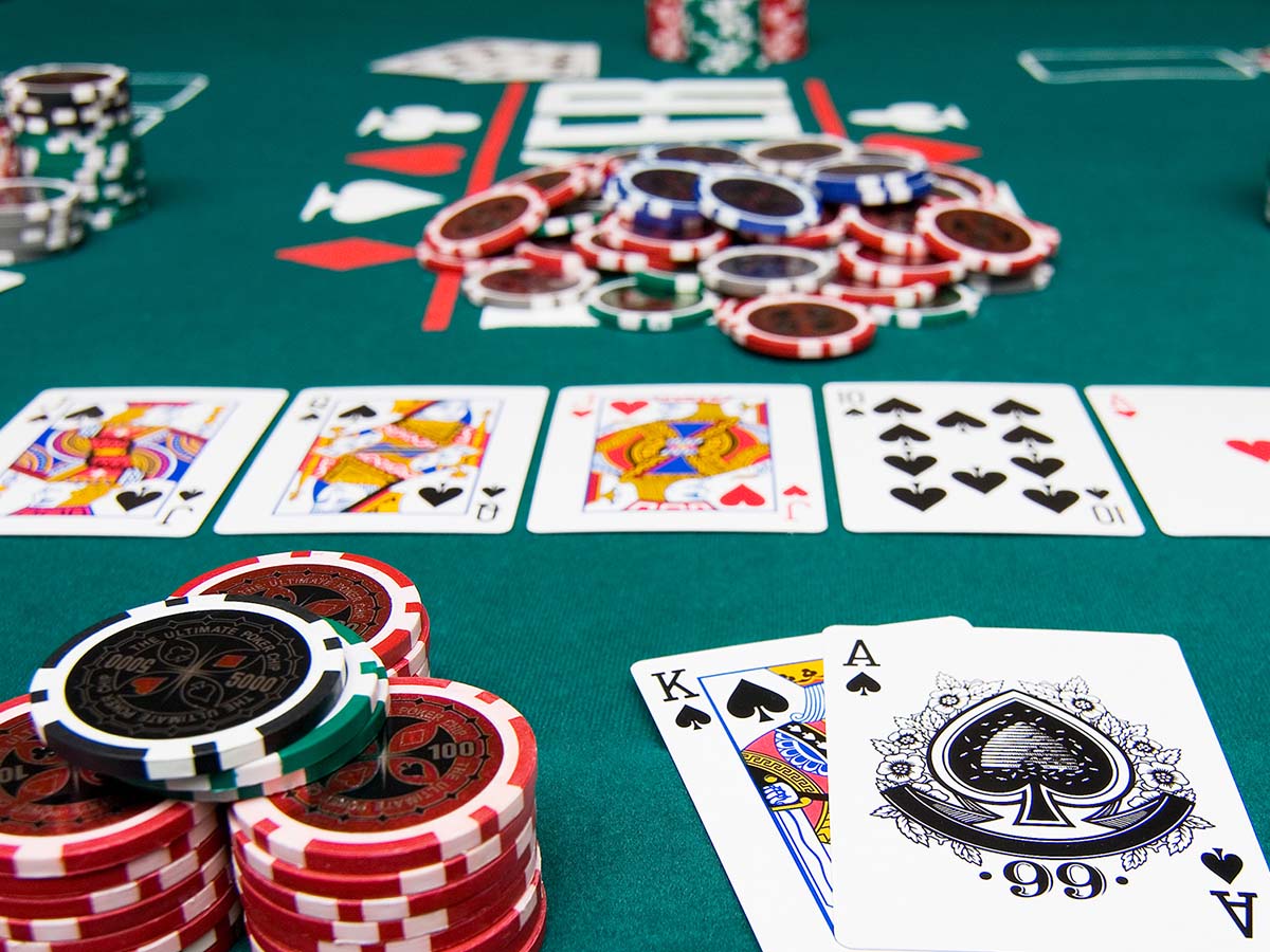 Gambling on poker with chips and cards on green table